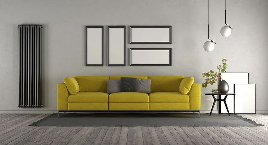 Tall black vertical radiator in a modern living room, supplied and fitted by Phoenix